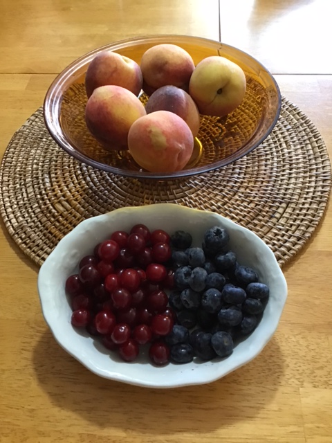 bowls with berries and peaches