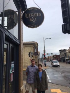 women and man standing outside of bookstore