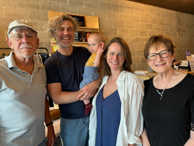 4 adults and a baby standing together