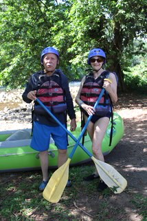 male and female standing in front of raft